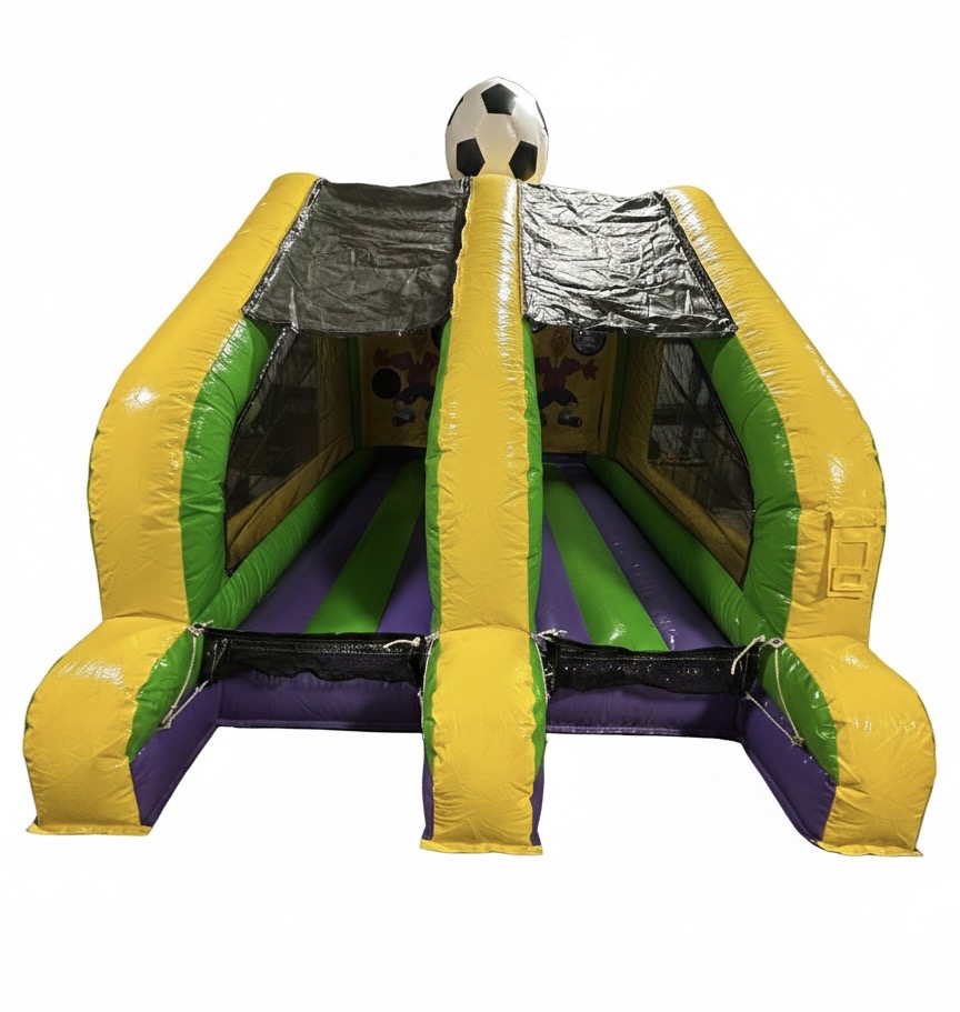 A wide-view photo of two dual-lane inflatable soccer shootout games side-by-side, featuring vibrant soccer ball graphics and target holes, set up for a large-scale community event in Columbus, Ohio.