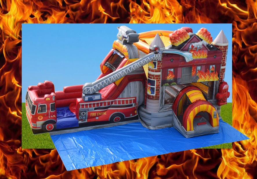 A massive inflatable event setup featuring a realistic red firetruck and a fire house bounce house with a slide, set against a dramatic backdrop of orange and yellow flames for an immersive hero theme in Central Ohio.