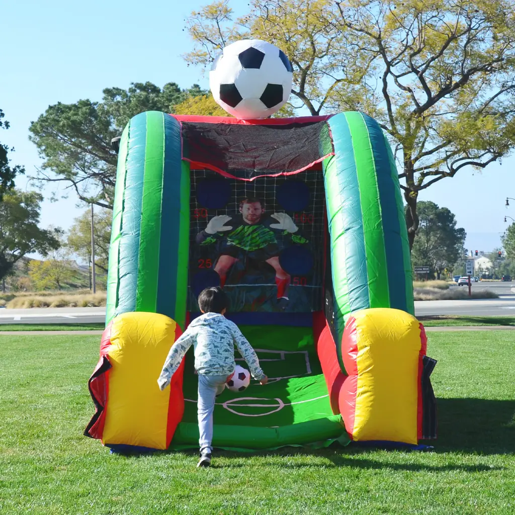 A professional inflatable soccer goal challenge with target holes in the backdrop, perfect for youth soccer team parties in Lancaster.